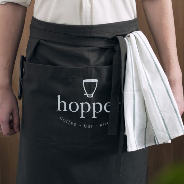 An image of a half-apron with a café logo printed on the front.
