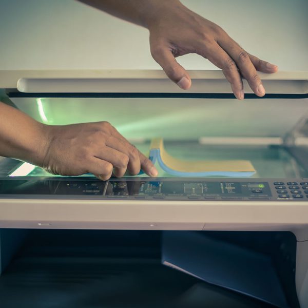 Image showing a person scanning a book on a photocopier.