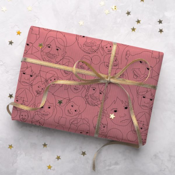 A gift wrapped with personalised wrapping paper. The design is comprised of line drawings of a family arranged in a tiling pattern.