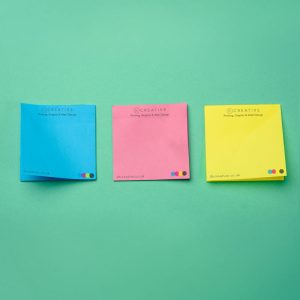 Multi-coloured sticky notes with a full colour design printed on them.